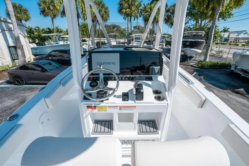 Slide: The Image of 2025 Sea Hunt Ultra 229 boat dashboard with Garmin navigation, steering wheel, and controls. - 15
