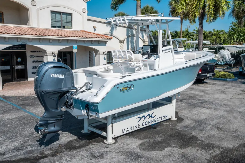 Slide: The Image of 2025 Sea Hunt Ultra 229 boat displayed at Marine Connection dealership. - 2