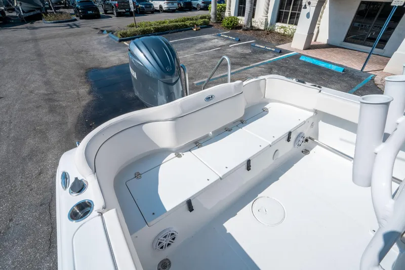 Slide: The Image of 2025 Sea Hunt Ultra 229 boat interior with Yamaha engine, parked in a lot. - 13