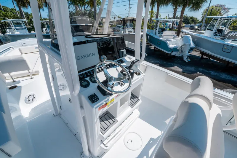 Slide: The Image of 2025 Sea Hunt Ultra 229 boat interior with Garmin navigation system and sleek steering wheel. - 16