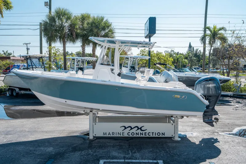 Slide: The Image of 2025 Sea Hunt Ultra 229 boat displayed at Marine Connection dealership. - 5