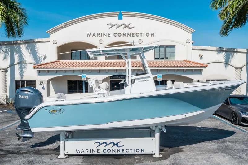 Slide: The Image of 2025 Sea Hunt Ultra 229 boat displayed at Marine Connection dealership. - 1