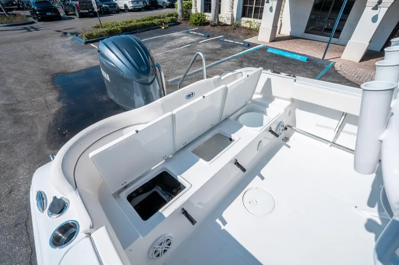 Slide: The Image of 2025 Sea Hunt Ultra 229 boat interior with storage compartments and Yamaha outboard motor. - 14