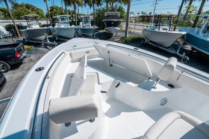 Slide: The Image of 2025 Sea Hunt Ultra 229 boat interior with seating and storage, displayed outdoors. - 24
