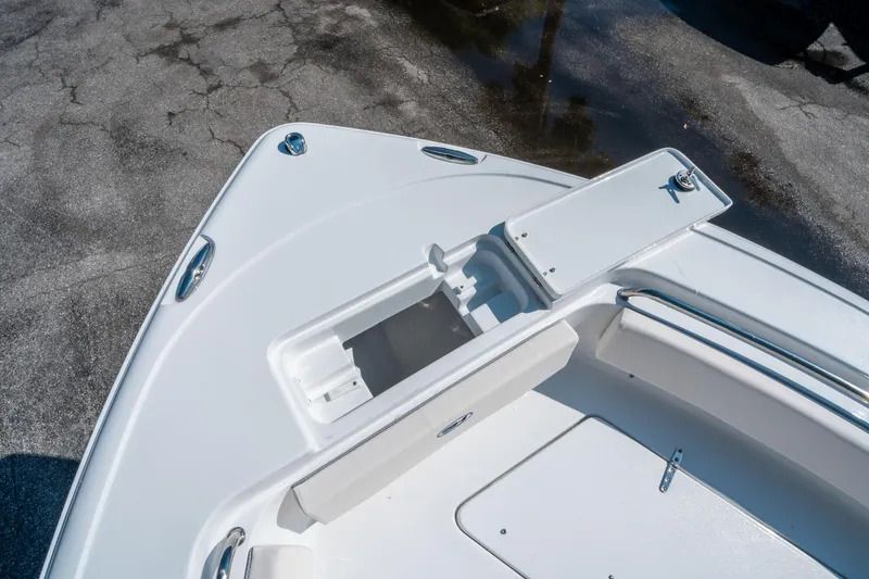 Slide: The Image of 2025 Sea Hunt Ultra 229 boat deck with open storage compartment. - 26