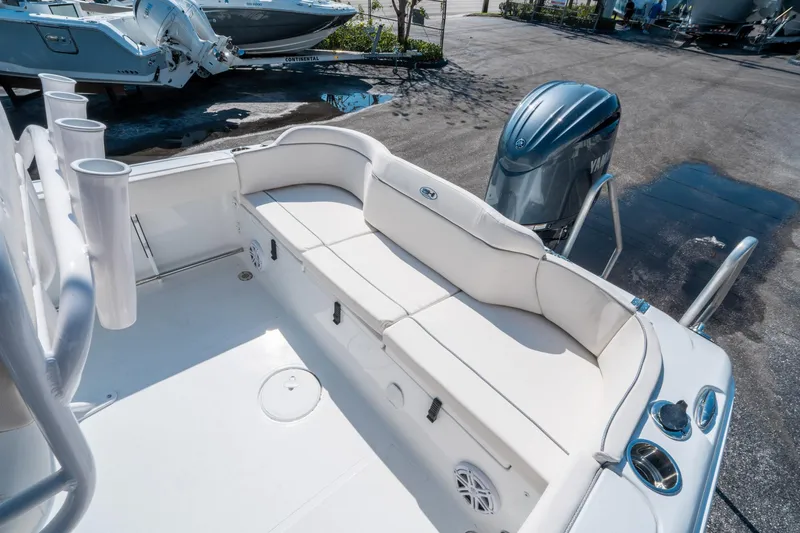 Slide: The Image of 2025 Sea Hunt Ultra 229 boat interior with seating and Yamaha outboard motor. - 12