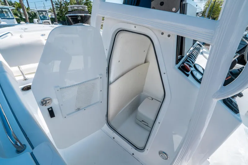 Slide: The Image of 2025 Sea Hunt Ultra 229 boat interior with open storage compartment. - 19