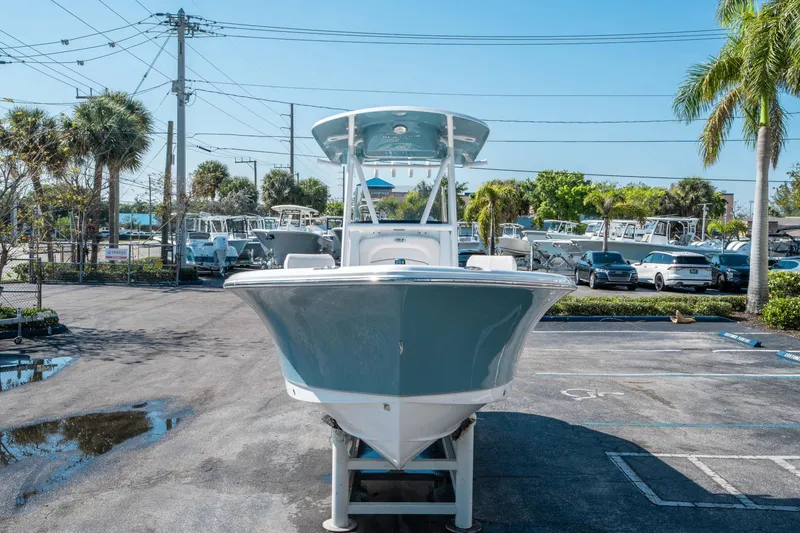 Slide: The Image of 2025 Sea Hunt Ultra 229 boat displayed in a parking lot with palm trees. - 7