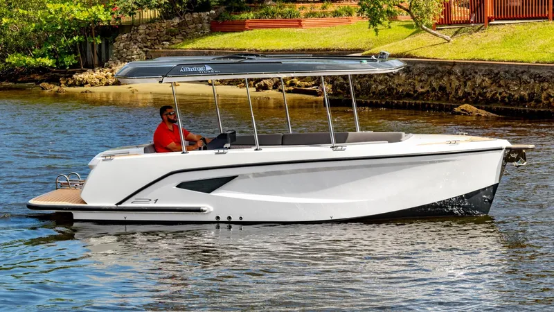 Slide: The Image of 2023 Alfastreet 21 Open boat cruising on a calm river with a person onboard. - 0