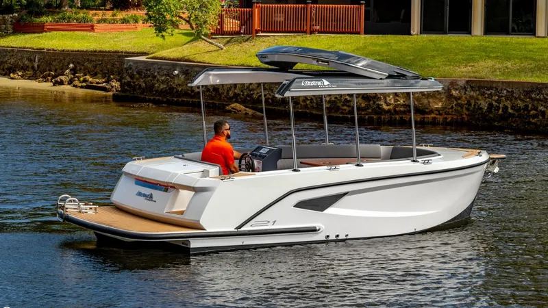 Slide: The Image of 2023 Alfastreet 21 Open boat cruising on a calm river near a grassy shoreline. - 4