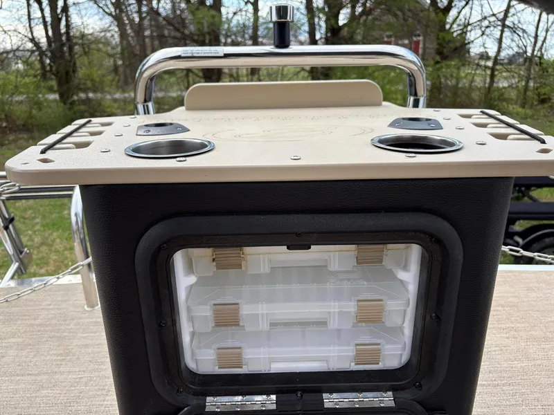 Slide: The Image of Barletta C22CC 2021 boat console with storage compartments and cup holders, outdoors. - 11