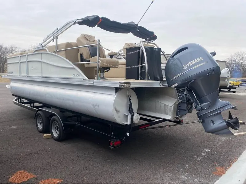 Slide: The Image of 2021 Barletta C22CC pontoon boat with Yamaha outboard motor on trailer. - 2