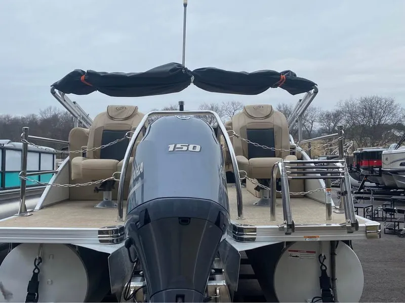 Slide: The Image of 2021 Barletta C22CC pontoon boat with Yamaha 150 engine, beige seating, and canopy. - 3