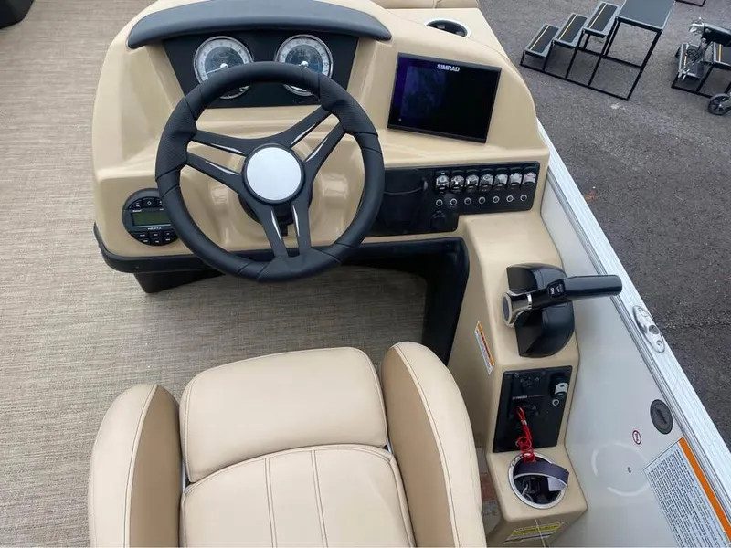 Slide: The Image of 2021 Barletta C22CC boat dashboard with steering wheel and control panel. - 5