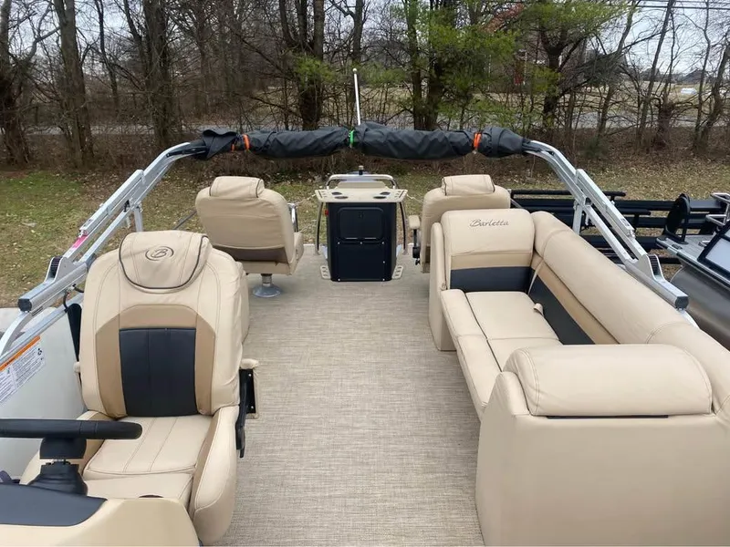 Slide: The Image of 2021 Barletta C22CC pontoon boat interior with beige seating and helm. - 6