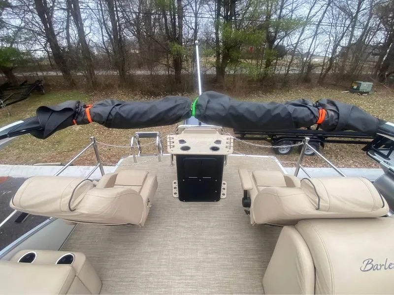 Slide: The Image of 2021 Barletta C22CC boat interior with beige seating and covered equipment. - 7