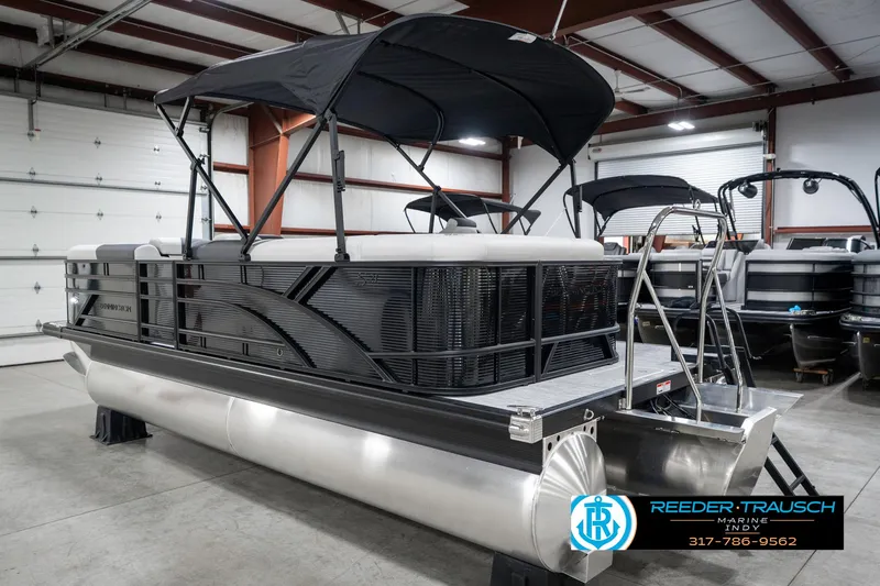 Slide: The Image of 2025 Bennington 21 SL pontoon boat with canopy in showroom. - 10