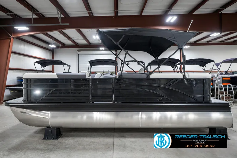 Slide: The Image of 2025 Bennington 21 SL pontoon boat in showroom, side view with canopy. - 11