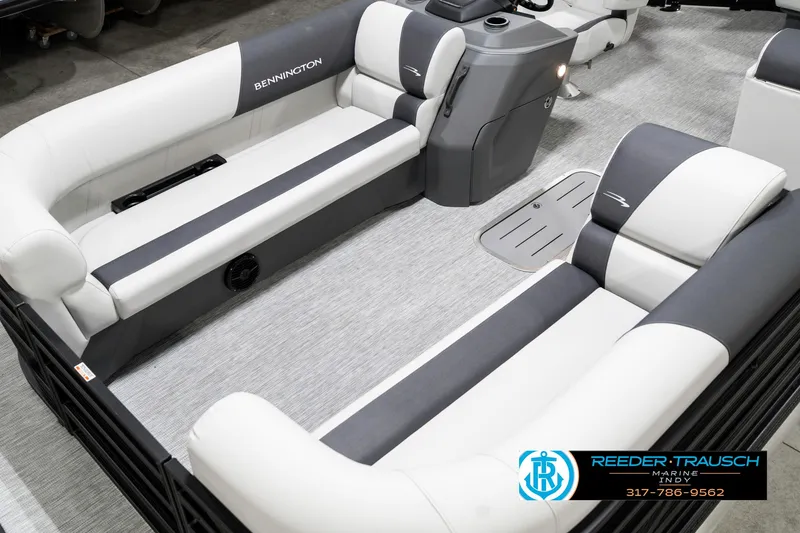 Slide: The Image of 2025 Bennington 21 SL pontoon boat interior with gray and white seating, showcased by Reeder-Trausch Marine. - 12