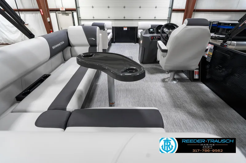 Slide: The Image of 2025 Bennington 21 SL boat interior with gray seating and steering console. - 19