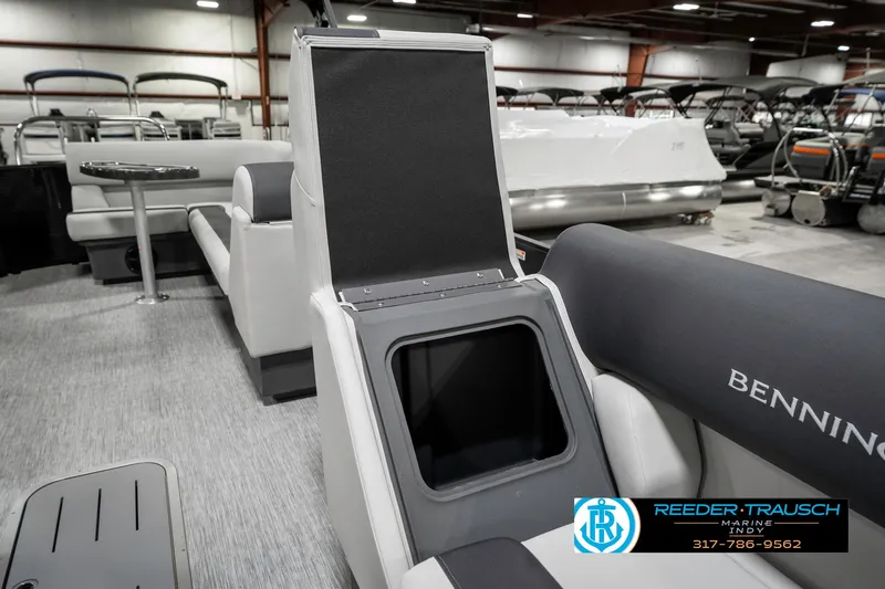 Slide: The Image of 2025 Bennington 21 SL boat interior with open storage compartment and seating. - 24