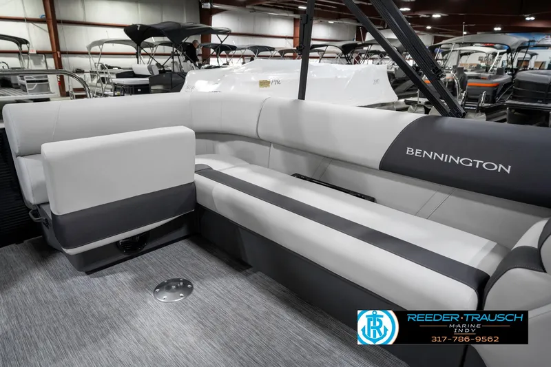 Slide: The Image of 2025 Bennington 21 SL pontoon boat interior with gray seating in showroom. - 27