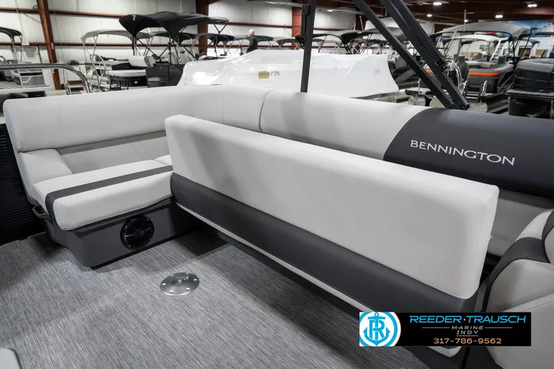 Slide: The Image of 2025 Bennington 21 SL pontoon boat interior with gray seating in showroom. - 28