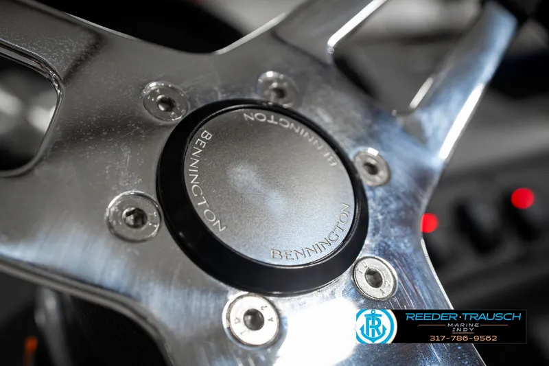 Slide: The Image of Steering wheel of 2025 Bennington 21 SL boat, featuring sleek metallic design. - 32