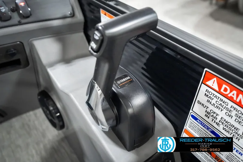 Slide: The Image of Throttle control of 2025 Bennington 21 SL boat with warning labels and branding. - 38