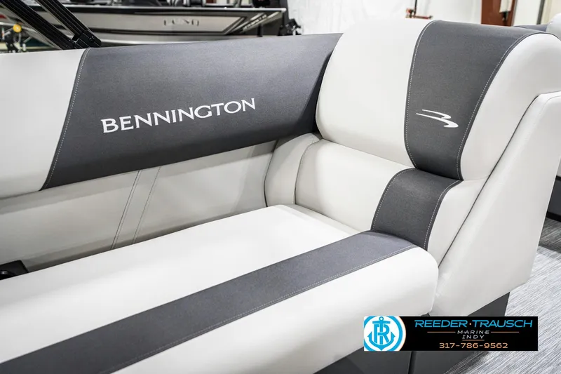 Slide: The Image of 2025 Bennington 21 SL boat interior with gray and white seating, featuring brand logo. - 41