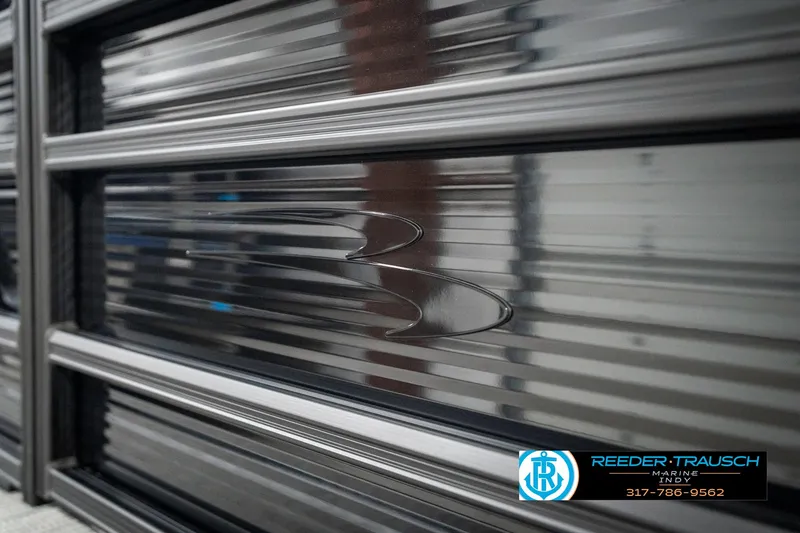 Slide: The Image of 2025 Bennington 21 SL boat detail with sleek metallic finish and logo. - 47