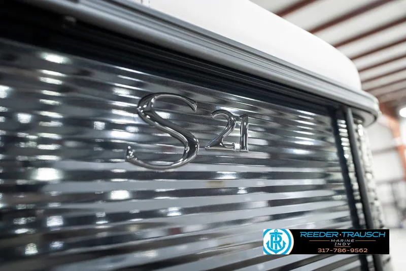 Slide: The Image of 2025 Bennington 21 SL boat with metallic finish, featuring "S21" emblem. - 49