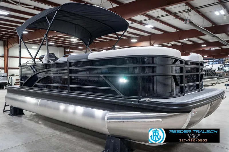 Slide: The Image of 2025 Bennington 21 SL pontoon boat in showroom with canopy and sleek design. - 6