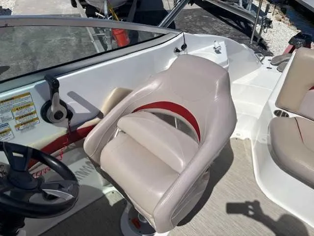 Slide: The Image of 2015 Hurricane SD 2200 DC OB boat interior with beige seating and steering wheel. - 15