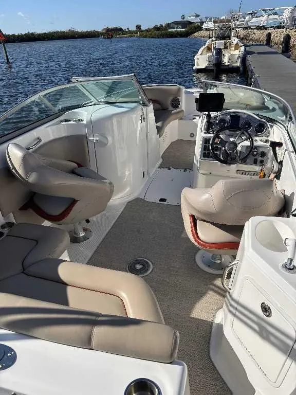 Slide: The Image of 2015 Hurricane SD 2200 DC OB boat interior with beige seating and steering console. - 2