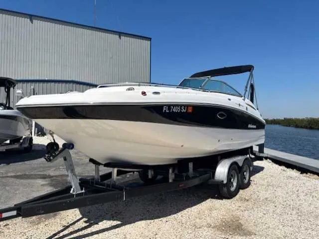 Slide: The Image of 2015 Hurricane SD 2200 DC OB boat on trailer, parked near water and building. - 6