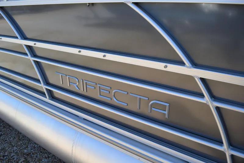 Slide: The Image of 2023 Trifecta 22RF LE 2.75 pontoon boat with sleek aluminum siding. - 3