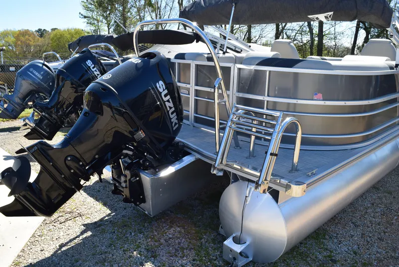 Slide: The Image of 2023 Trifecta 22RF LE 2.75 pontoon boat with dual Suzuki outboard motors. - 5
