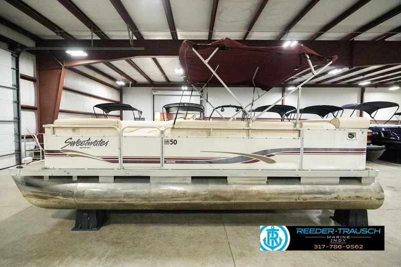 Slide: The Image of 2001 Sweetwater SW 20 RE pontoon boat in indoor storage facility. - 11