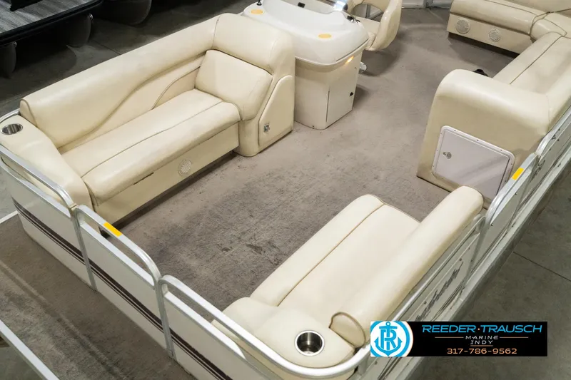 Slide: The Image of 2001 Sweetwater SW 20 RE pontoon boat interior with beige seating and console. - 12