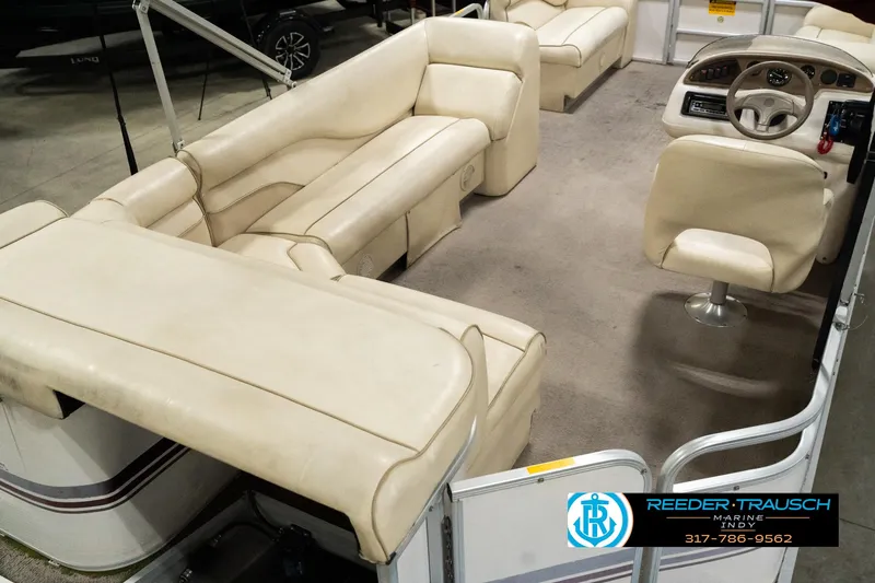 Slide: The Image of 2001 Sweetwater SW 20 RE pontoon boat interior with beige seating and steering console. - 14