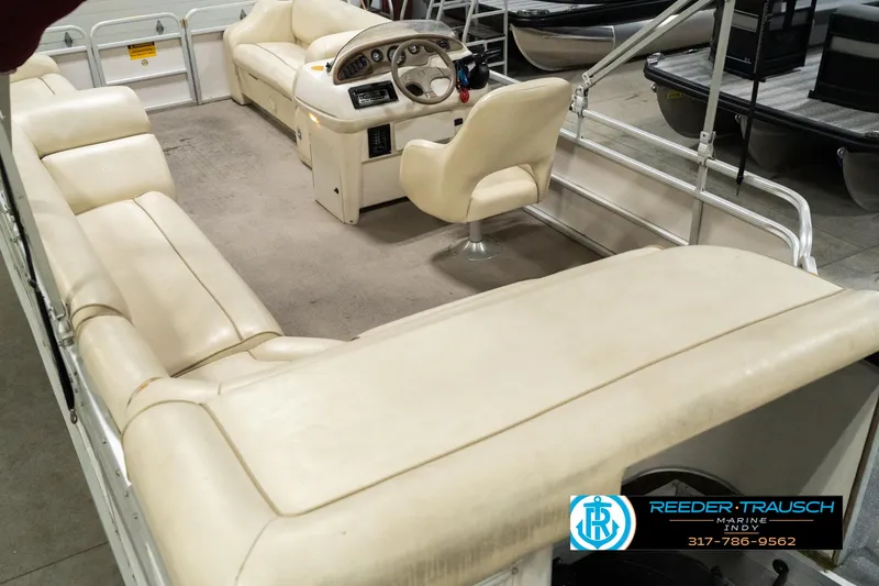 Slide: The Image of 2001 Sweetwater SW 20 RE pontoon boat interior with beige seating and steering console. - 15