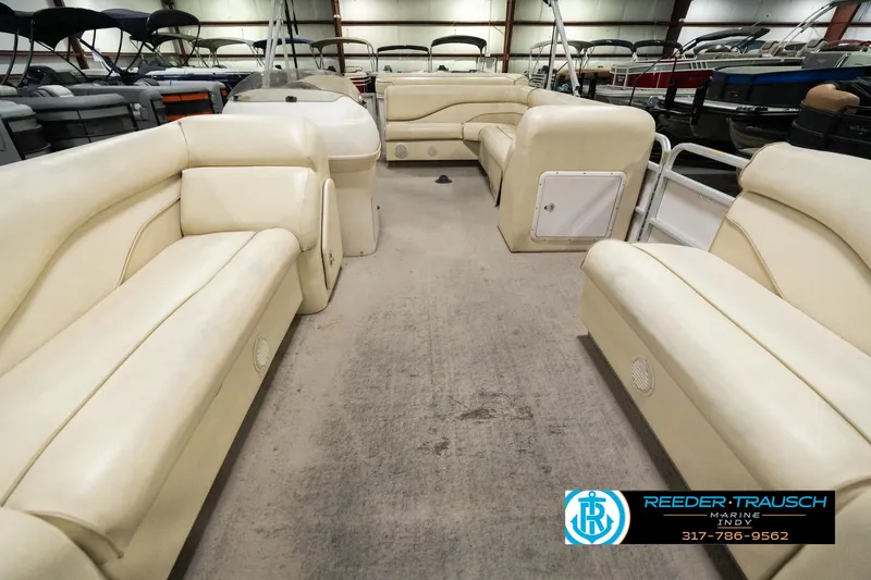 Slide: The Image of 2001 Sweetwater SW 20 RE pontoon boat interior with beige seating in a showroom. - 16