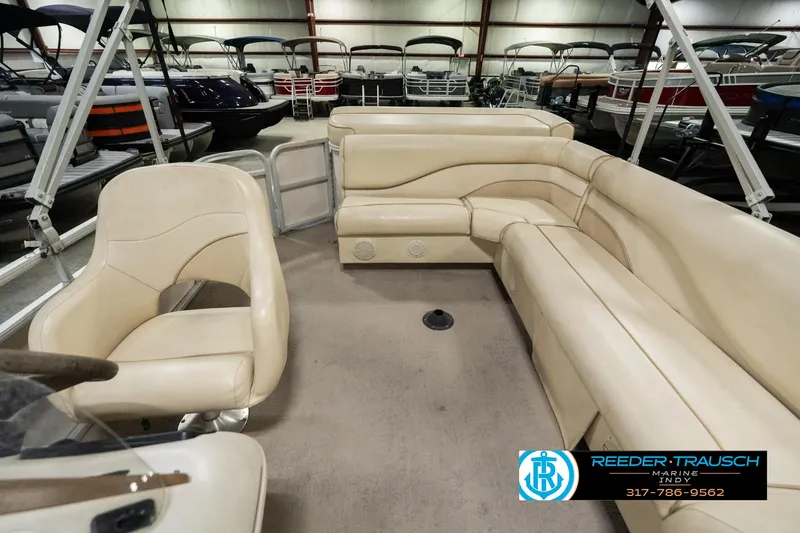 Slide: The Image of 2001 Sweetwater SW 20 RE pontoon boat interior with beige seating in showroom. - 17