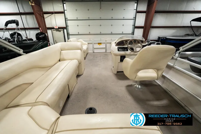 Slide: The Image of 2001 Sweetwater SW 20 RE pontoon boat interior with beige seating and steering console. - 18