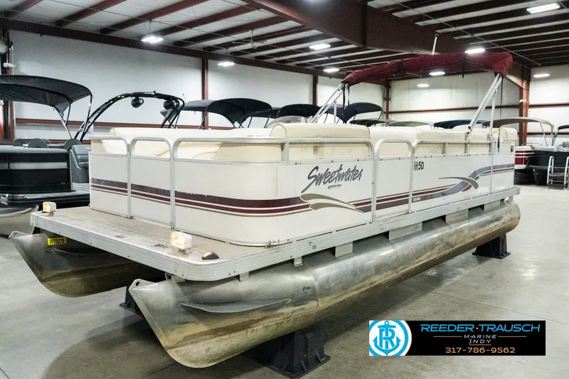Slide: The Image of 2001 Sweetwater SW 20 RE pontoon boat in indoor showroom. - 2