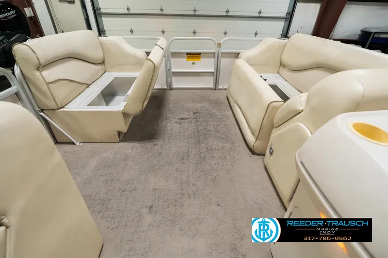 Slide: The Image of 2001 Sweetwater SW 20 RE pontoon boat interior with beige seating and storage compartments. - 21