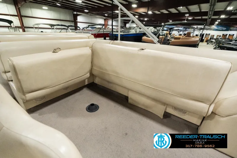 Slide: The Image of 2001 Sweetwater SW 20 RE boat interior with beige seating in a showroom. - 24