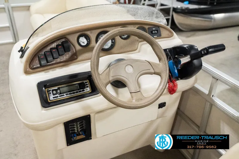 Slide: The Image of Steering console of a 2001 Sweetwater SW 20 RE boat with gauges and controls. - 26