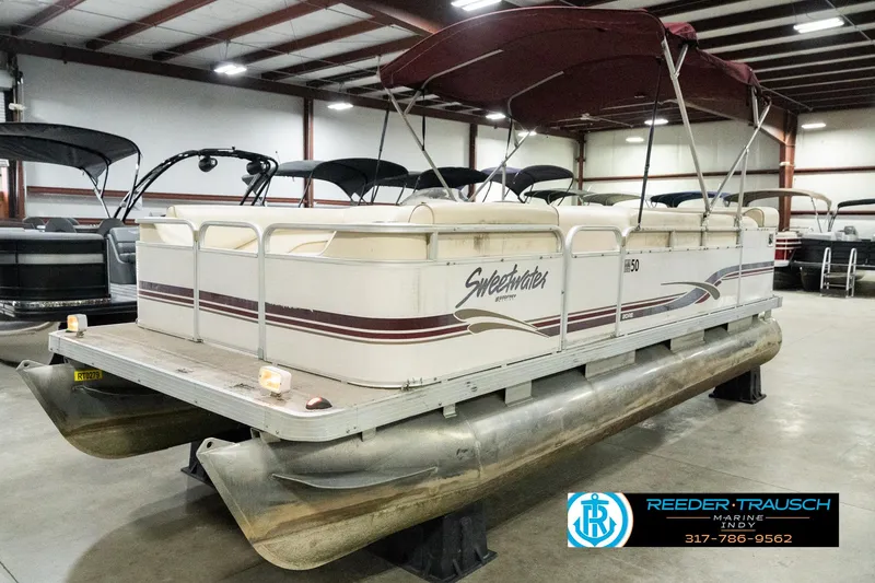 Slide: The Image of 2001 Sweetwater SW 20 RE pontoon boat with canopy in indoor showroom. - 3